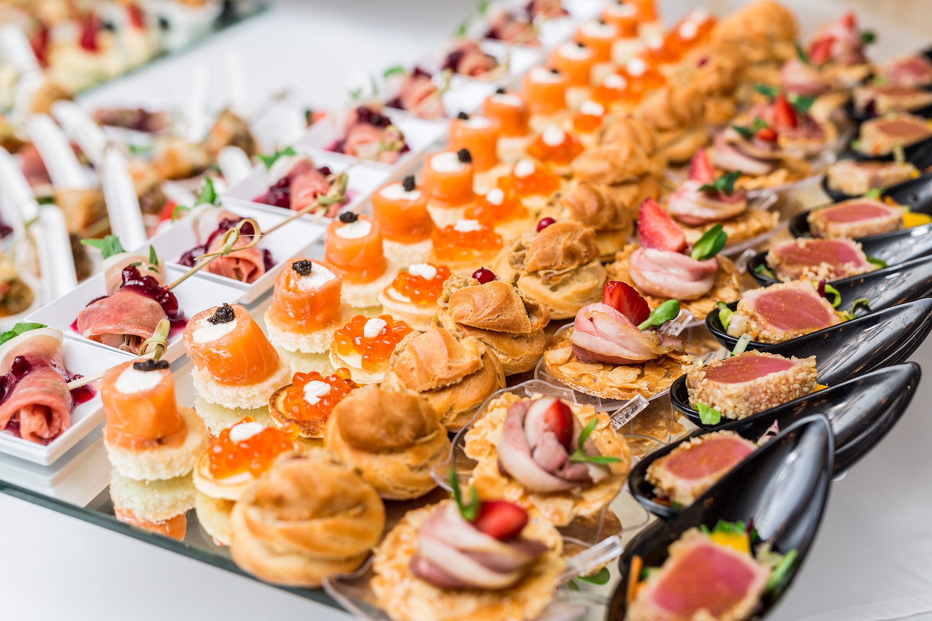 Gourmet appetizers: caviar, venison, tuna and salmon.