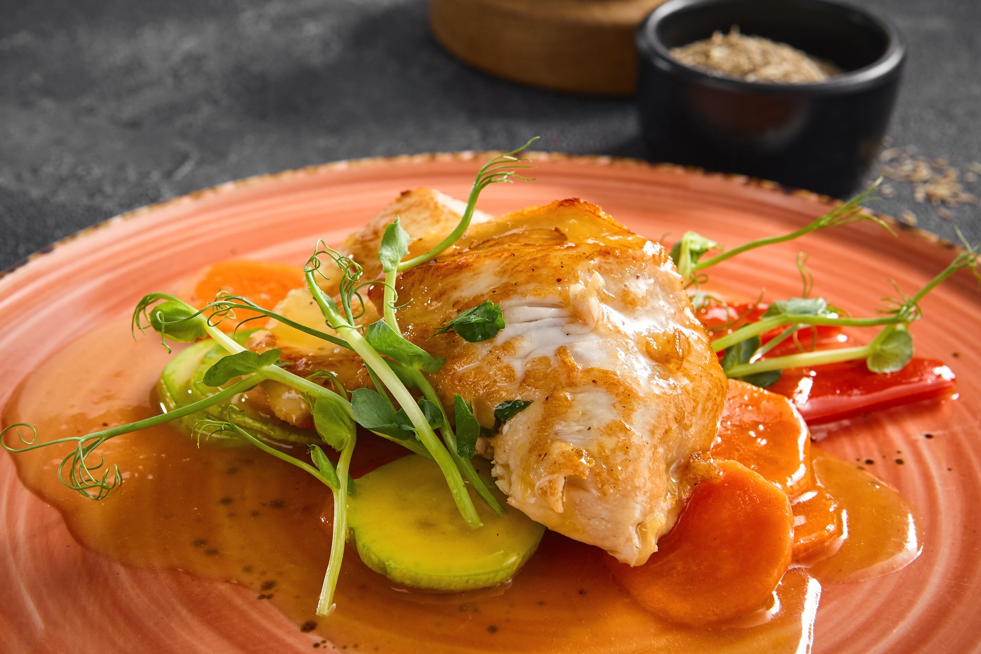 Succulent pan-fried turkey fillet served with crisp vegetables and a tangy sweet chili sauce, beautifully plated on a coral dish